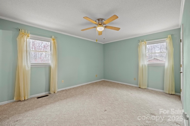 unfurnished bedroom featuring a textured ceiling, carpet, visible vents, and crown molding