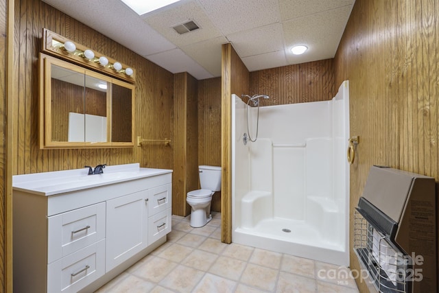 full bathroom featuring visible vents, wood walls, toilet, and a walk in shower