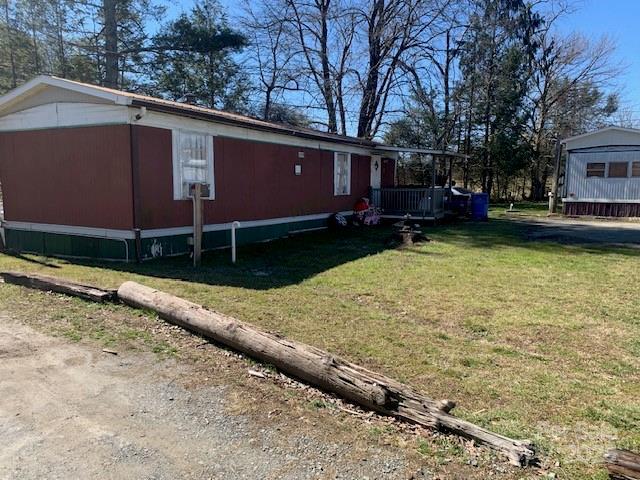 view of side of home featuring a lawn