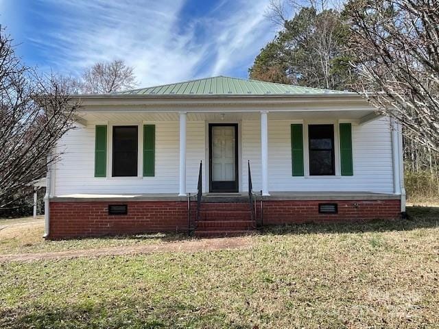 bungalow-style house featuring covered porch and a front lawn