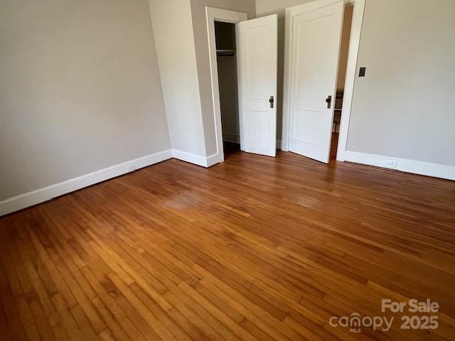 unfurnished bedroom featuring wood-type flooring