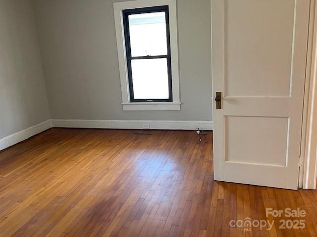 empty room featuring wood-type flooring