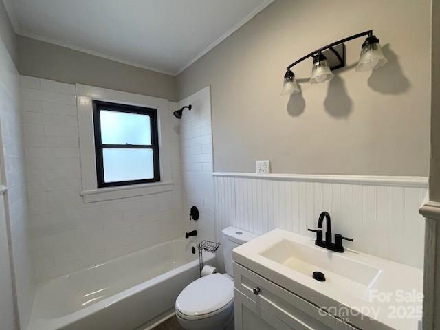 full bathroom featuring tiled shower / bath combo, vanity, and toilet