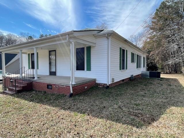 exterior space featuring covered porch and a lawn