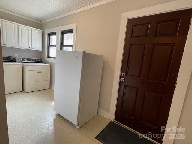 washroom featuring cabinets, washer and clothes dryer, and crown molding