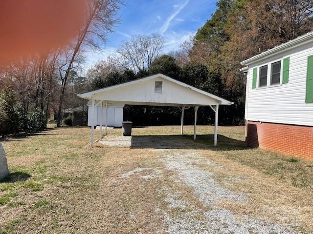 exterior space featuring a carport and a lawn