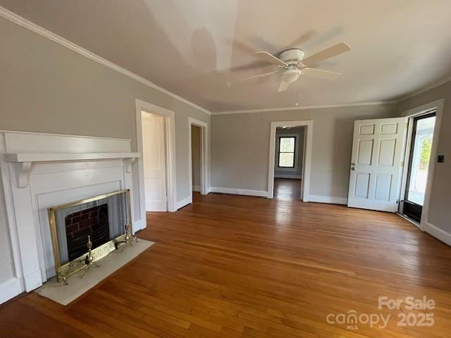 unfurnished living room with a fireplace with flush hearth, baseboards, and wood finished floors