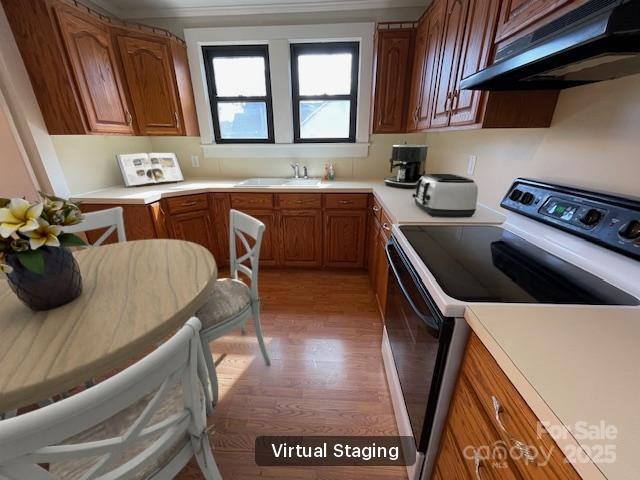 5135 Tucker Ave, Kannapolis, NC 28081 - kitchen with exhaust hood, range with electric cooktop, light wood finished floors, and light countertops