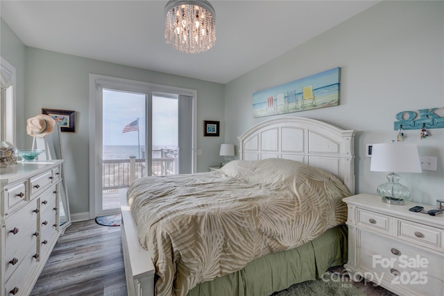 bedroom featuring baseboards, access to outside, a chandelier, and light wood-type flooring