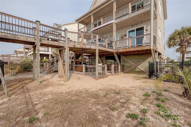 back of house featuring a wooden deck and fence