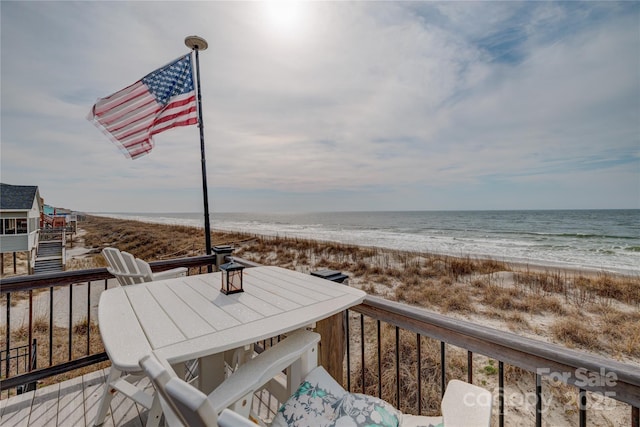 wooden terrace with a beach view and a water view