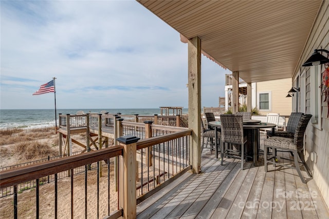 wooden terrace with a beach view and a water view