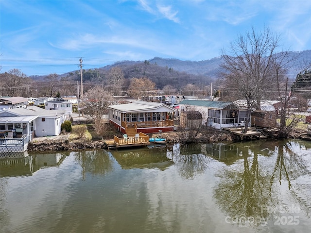 exterior space with a water and mountain view