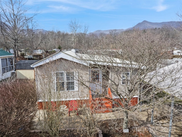 view of side of home with a mountain view