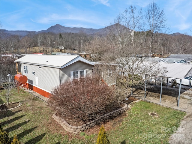 exterior space with a mountain view and a yard