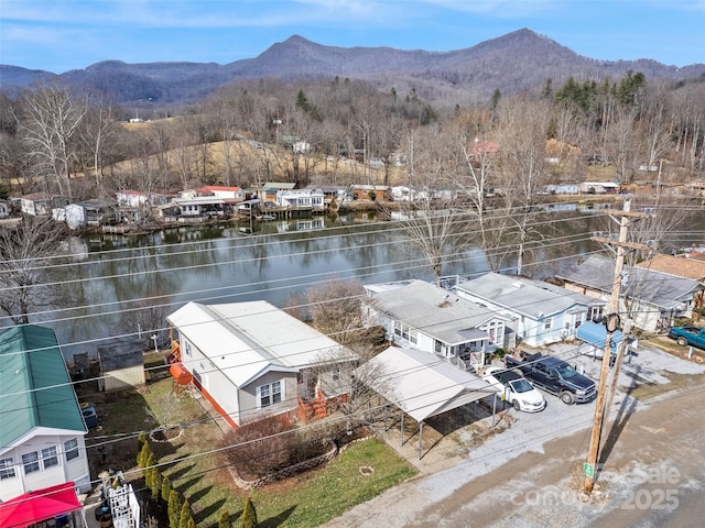 drone / aerial view featuring a water and mountain view