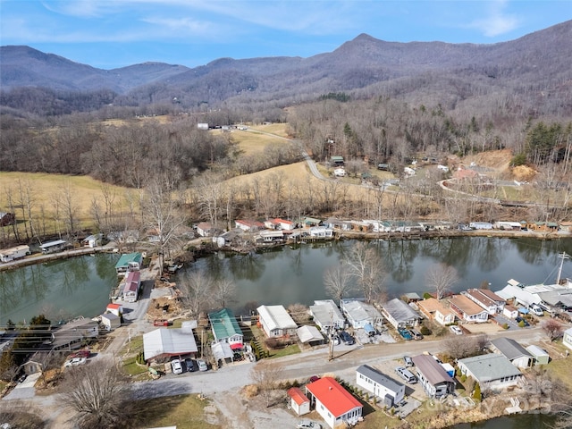 drone / aerial view featuring a water and mountain view