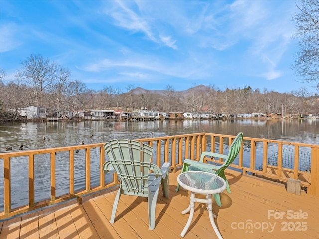 view of dock featuring a deck with water view