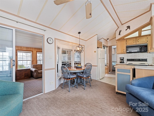 kitchen with pendant lighting, lofted ceiling, white refrigerator, range with electric stovetop, and light colored carpet