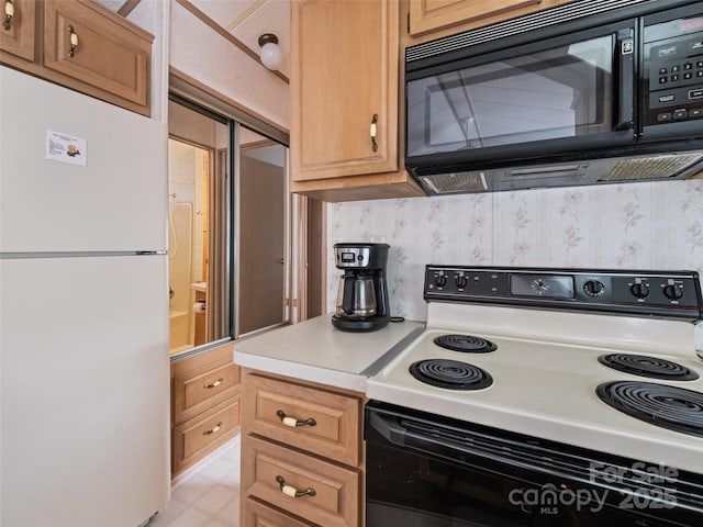 kitchen with white refrigerator and electric range