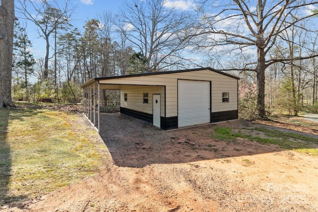 detached garage with dirt driveway