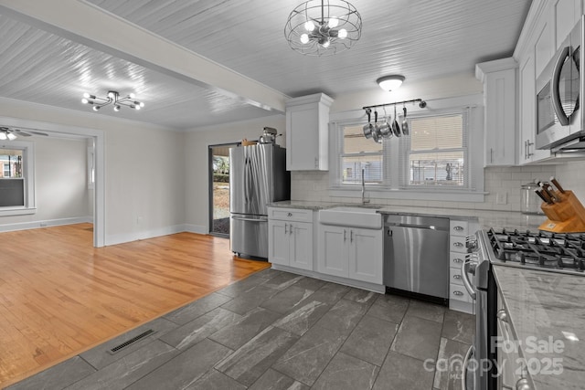 1216 Innis Ave, Kannapolis, NC 28081 - kitchen with a sink, an inviting chandelier, visible vents, and stainless steel appliances