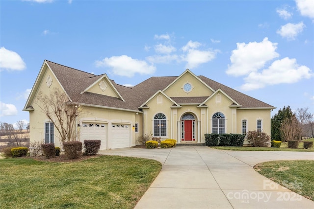 view of front of house featuring a front yard and a garage