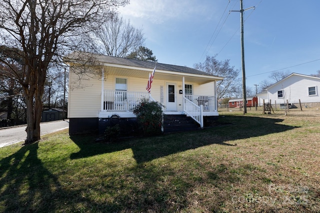 view of front of house with covered porch and a front lawn