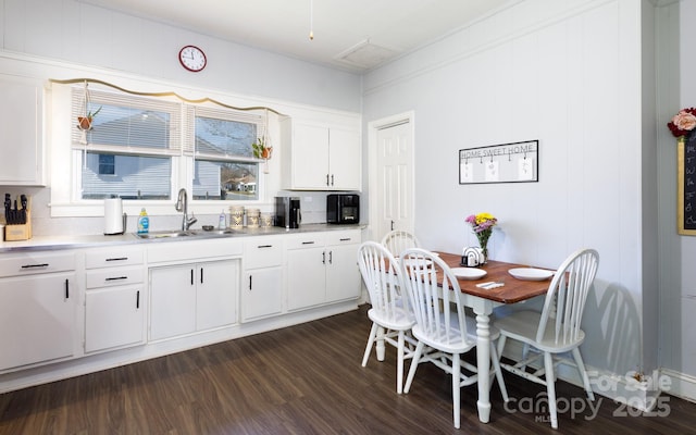 kitchen featuring sink, white cabinetry, and dark hardwood / wood-style floors