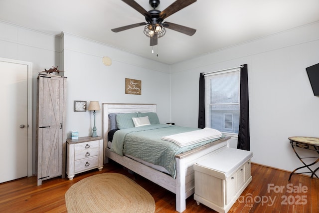 bedroom with ceiling fan and dark hardwood / wood-style flooring