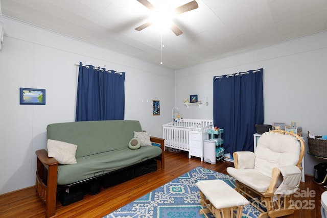 living area with hardwood / wood-style flooring and ceiling fan