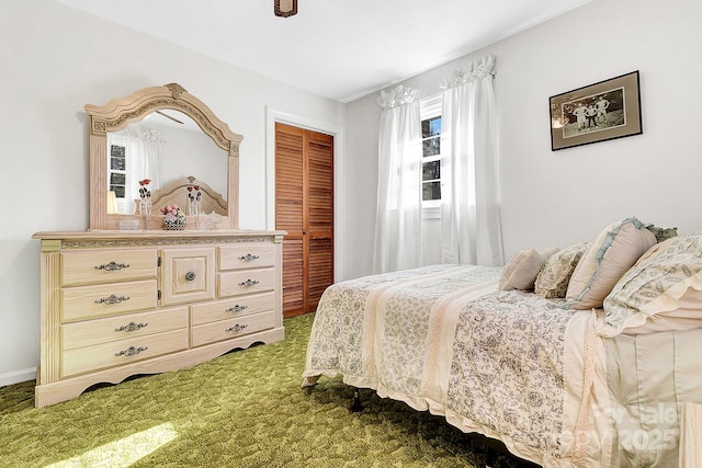 bedroom with ceiling fan, carpet floors, and a closet