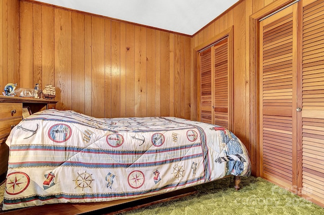 bedroom featuring carpet floors and wooden walls