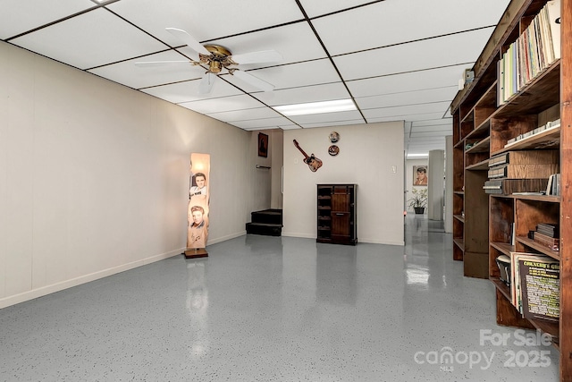 interior space featuring a paneled ceiling and ceiling fan