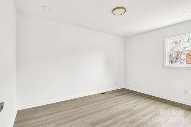 spare room with hardwood / wood-style floors