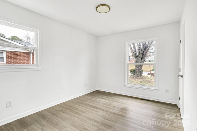 spare room featuring light hardwood / wood-style floors