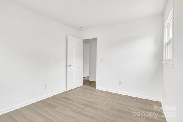 spare room with light wood-type flooring