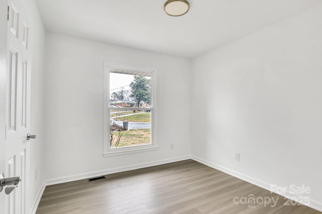 empty room featuring wood-type flooring