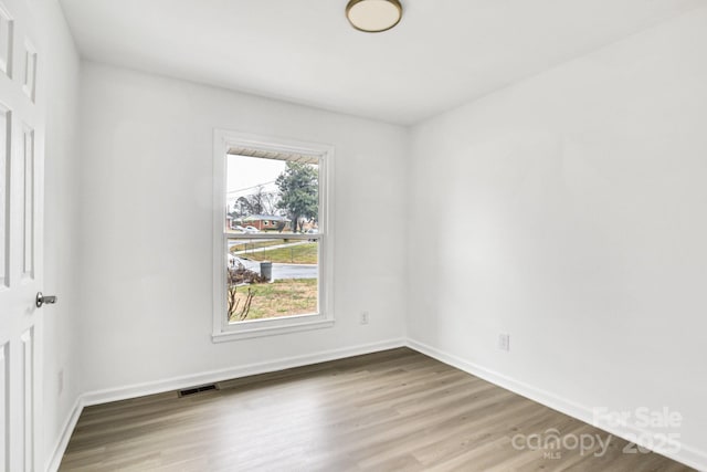 spare room featuring hardwood / wood-style floors