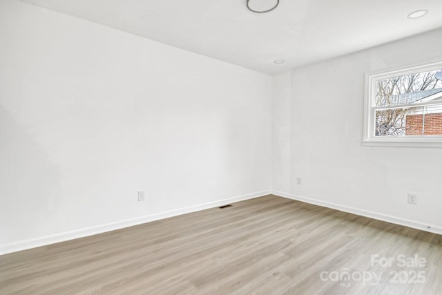 unfurnished room featuring light wood-type flooring