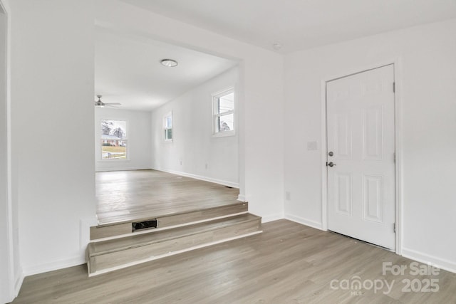 entryway with light hardwood / wood-style floors and ceiling fan