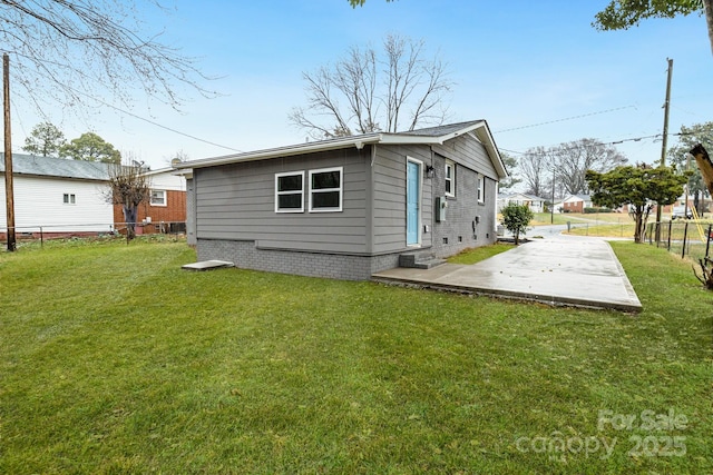 back of house with a yard and a patio area