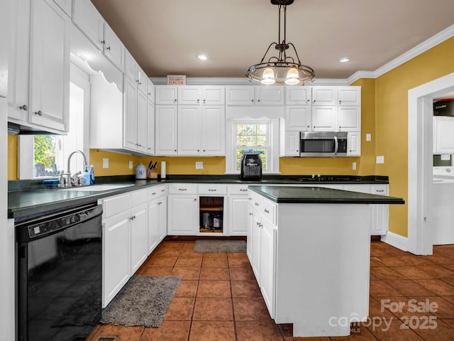 kitchen featuring dishwasher, dark countertops, and white cabinetry