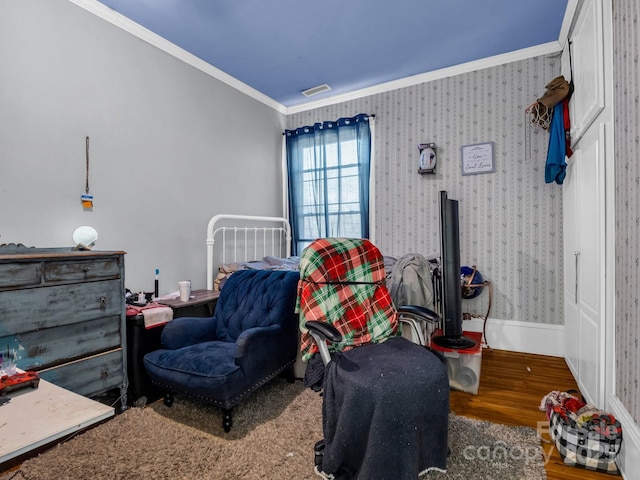 bedroom with wallpapered walls, visible vents, baseboards, wood finished floors, and crown molding