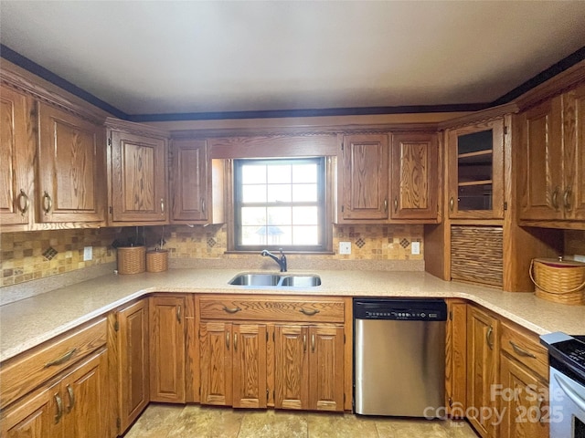 kitchen featuring a sink, brown cabinets, stainless steel appliances, and light countertops