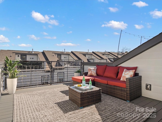 view of patio with outdoor lounge area, a residential view, and a balcony