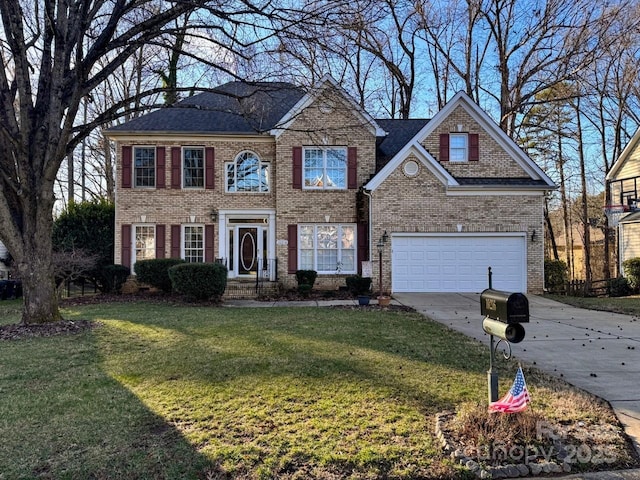 colonial house featuring a front yard, concrete driveway, brick siding, and an attached garage