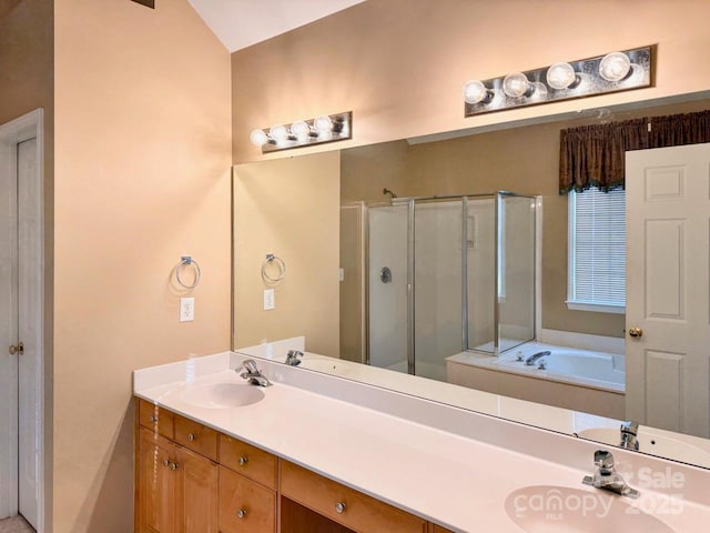 bathroom with double vanity, a stall shower, a sink, and a bath