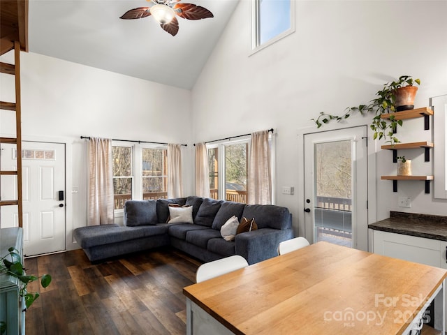 living room featuring ceiling fan, high vaulted ceiling, and dark hardwood / wood-style flooring