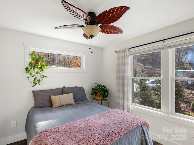 bedroom with multiple windows and ceiling fan